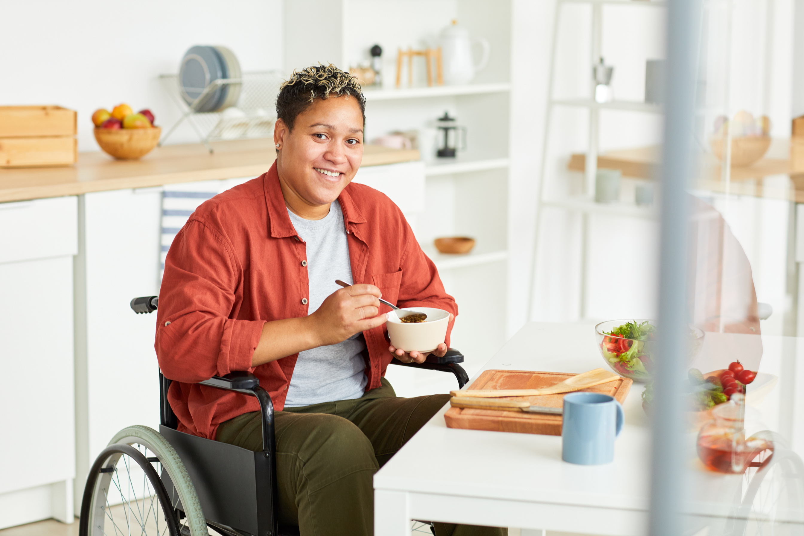 Disabled woman having breakfast